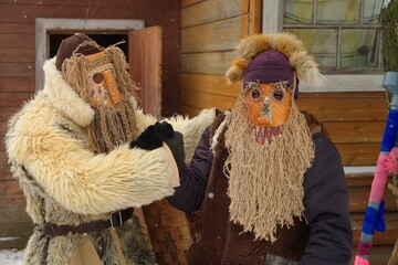 People in demon masks are preparing for caroling in Russia.