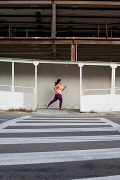 Side view of woman jogging on street