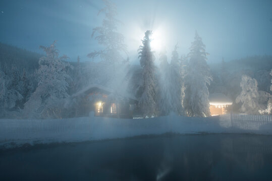 Chena Hot Springs by snow covered trees during night