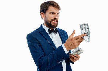 happy man scatter money on light background suit model business finance