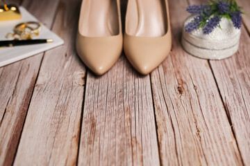 Template, empty space for text. Copy space on the background of a blurred image of heels, jewelry. Wood wallpaper.