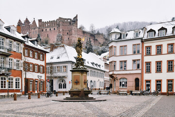 Heidelberg, Germany -  Old square called 'Kornmarkt' in old city center with fountain and view on...