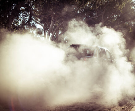 Off-road vehicle moving on dirt road at desert