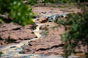 Water flooding over red rocks