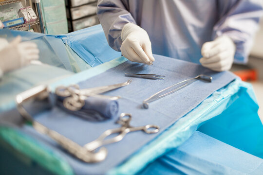 Midsection of doctor holding dental equipment in operating room