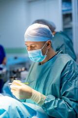 Medical team performing surgical operation in modern operating room