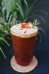 Strawberry Soda and Espresso Shot top with fresh strawberries in a glass placed on the table. 