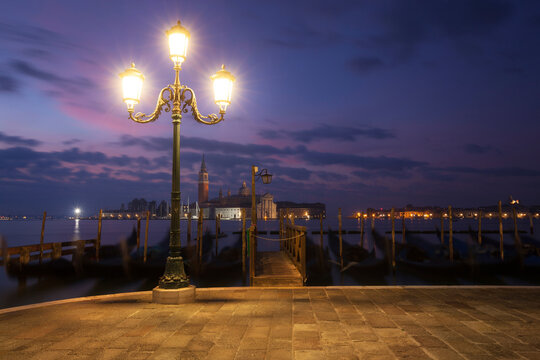 Piazza San Marco by Grand Canal against sky at dusk