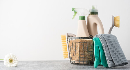 Brushes, sponges, rubber gloves and natural cleaning products in the basket.  Eco-friendly cleaning...