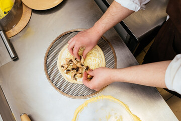 closeup hand of chef making pizza
