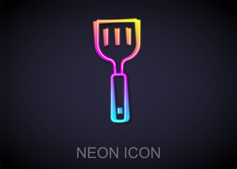 Fototapeta premium Glowing neon line Spatula icon isolated on black background. Kitchen spatula icon. BBQ spatula sign. Barbecue and grill tool. Vector.