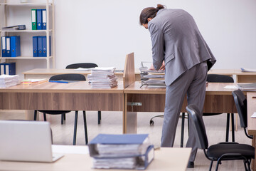 Young male employee in industrial espionage concept