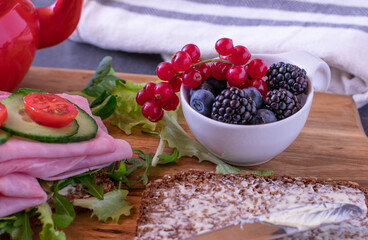 A bowl of fresh and ripe berries on a breakfast table