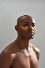 Male wearing orange eye mask while staring far