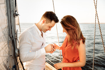 A guy puts a ring on his girlfriend, a marriage proposal on a yacht, she said YES