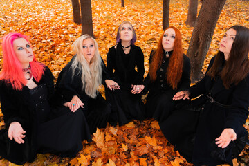 Coven of witches, a group of friends as witches on Halloween perform a ritual, lead a round dance...