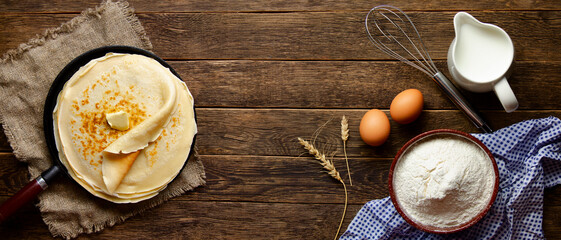Shrovetide festival. Russian pancakes on wooden background.