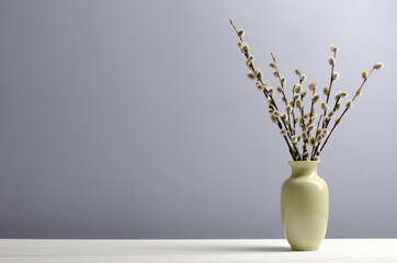a vase with a willow on a table. Easter, spring background © Anton
