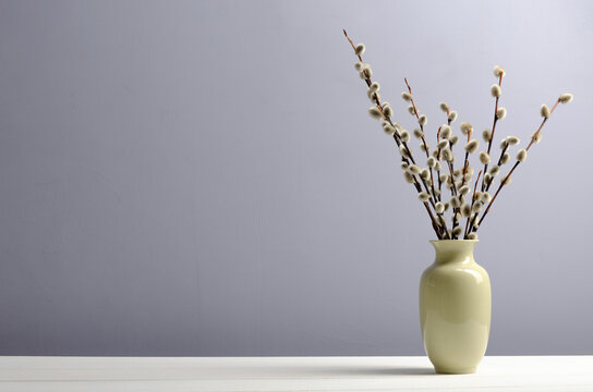 a vase with a willow on a table. Easter, spring background