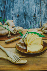 Fototapeta premium Fresh ginger root on the wooden table
