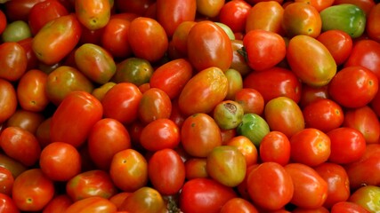 Little red and orange cherry tomatoes that are sold in traditional markets