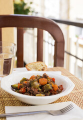 dish of vegetable stew. stewed eggplant, minced meat, carrots, peppers, onion squid