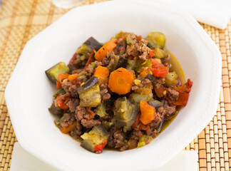 dish of vegetable stew. stewed eggplant, minced meat, carrots, peppers, onion squid