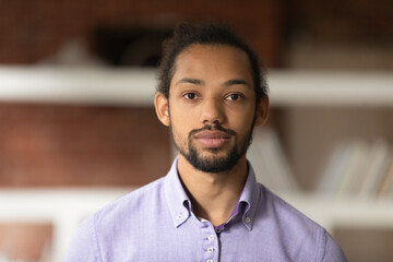 Profile picture of serious young African American male employee or worker pose in office or...