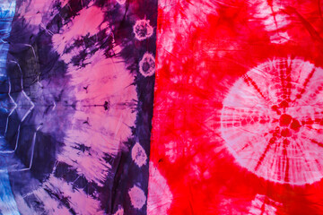 abstract pattern background of colorful traditional shibori tie dyed fabric with crumple creases and wrinkles 
