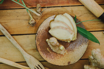 Fresh ginger root on the wooden table