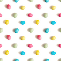 Seamless pattern with colorful painted eggs isolated on a white background. Easter concept. Top view, flat lay.