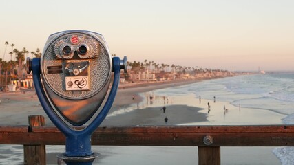 Metallic stationary observation tower viewer, waterfront old binoculars, Oceanside pier, California...