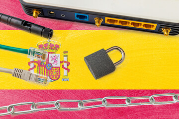 Spain Internet censorship and security concept. Flag in the background of the internet connection switch, wires and a lock with chain.