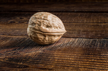 one whole walnut, close-up on the table