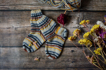 Colorful socks on vintage wooden background