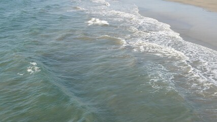 Pacific ocean big waves splashing, California coast USA. Water surface texture and sea foam. Seascape near beach, tide of blue water. Frome above, top down high angle view. Sunny tropical summer day.