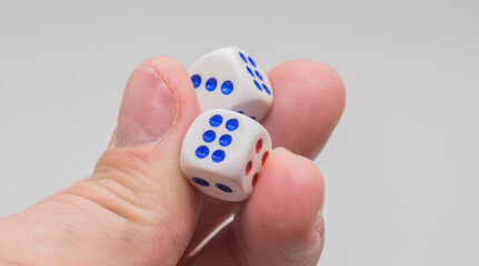 Two dice with numbers three and six in hand
