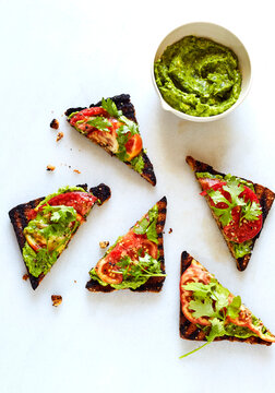 Overhead View Of Open Faced Sandwiches And Chutney Over White Background