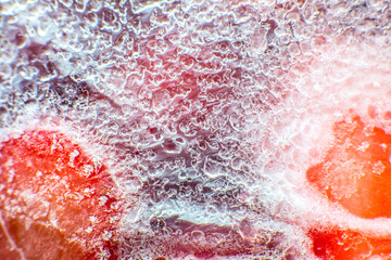 Frozen strawberries texture. Close up. Cold fruit in snow.