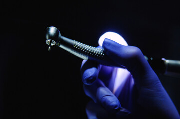 Dentist hand with drill illustrates the operation of the dentist dental drill machine