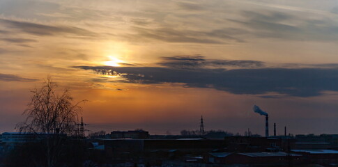 Sunset over the industrial area of the city in winter