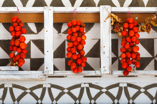 Tomatoes drying on a traditionally decorated wall of a house in Pyrgi