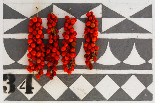 Tomatoes drying on a traditionally decorated wall of a house in Pyrgi.