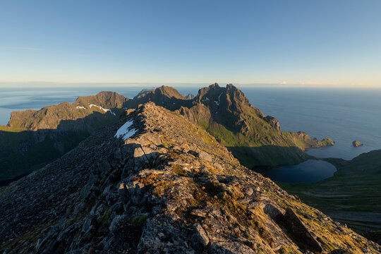 Small figue of distant hiker on summit ridge of Mengelsdalstind, Lofotodden national park, Moskenes&oslash;y, Lofoten Islands, Norway
