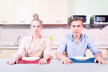 Fototapeta premium Young family with empty table in the kitchen. there
