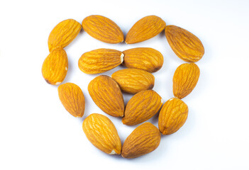 Almond nuts lying on white background. Healthy sport food. Vegan concept. Close up.