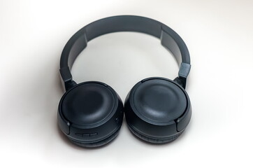 Black wireless headphones for audio electronic devices close up on white background