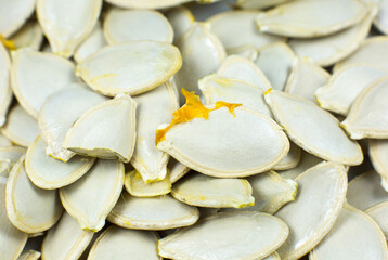 Fresh Pumpkin seeds background. Close up shot.