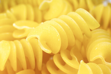Close up uncooked spiral pasta fusilli background.