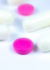 Obraz na płótnie Canvas Colored pills on white background. Close up. Medical treatment concept.